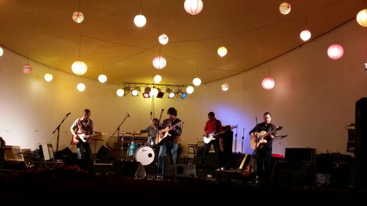 Die Band auf einer Bühne unter Lampions
